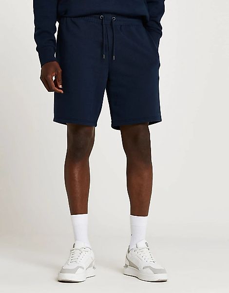 River Island – Schmal geschnittene Jersey-Shorts in Marineblau mit „RI“-Log günstig online kaufen