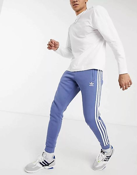 adidas Originals – adicolor – Jogginghose mit drei Streifen in Blau günstig online kaufen