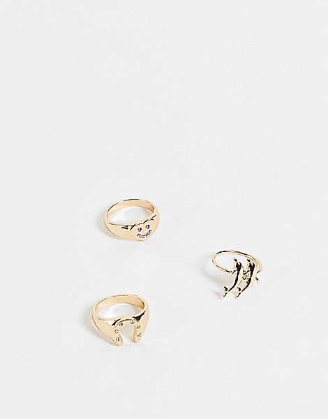 ASOS DESIGN – 3er-Pack goldfarbene Ringe mit Delfin-, Hufeisen- und fröhlic günstig online kaufen