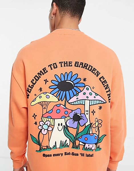 ASOS DESIGN – Oversize-Sweatshirt in Orange mit Cartoon-Rückenprint günstig online kaufen