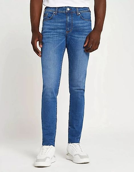 River Island – Eng geschnittene Jeans in Blau mit unbehandeltem Saum günstig online kaufen