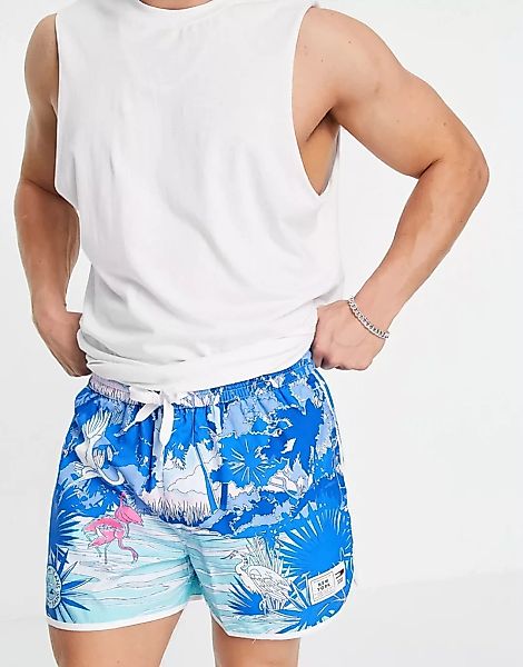 Tommy Jeans – Lauf-Shorts mit durchgehendem Palmen-Szenenprint in Blau günstig online kaufen