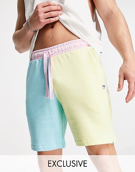 PUMA – Downtown – Asymmetrische Shorts in Grün und Rosa günstig online kaufen