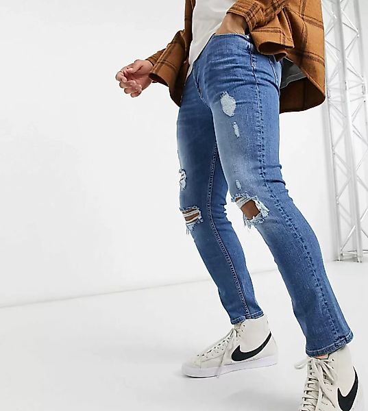 ASOS DESIGN – Enge Jeans in mittlerer Waschung mit starken Rissen-Blau günstig online kaufen