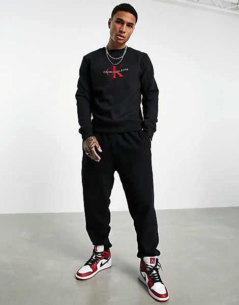 Calvin Klein Jeans – Sweatshirt in Schwarz mit beflocktem Monogramm-Logo günstig online kaufen