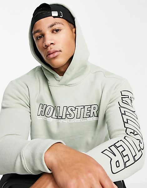 Hollister – Kapuzenpullover in Grün mit Logo in der Mitte und am Ärmel günstig online kaufen
