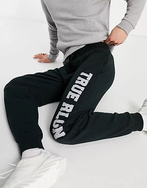 True Religion – Schmal geschnittene Jogginghose mit großem Markenlogo-Grau günstig online kaufen