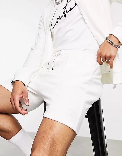 The Couture Club x ellesse – Carlos – Shorts mit Logo in Beige-Neutral günstig online kaufen