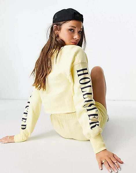Hollister – Sweatshirt mit Ärmellogo in Gelb günstig online kaufen