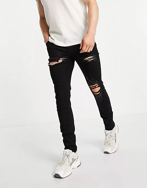ASOS DESIGN – Enge Jeans in Schwarz mit auffälligen Zierrissen günstig online kaufen