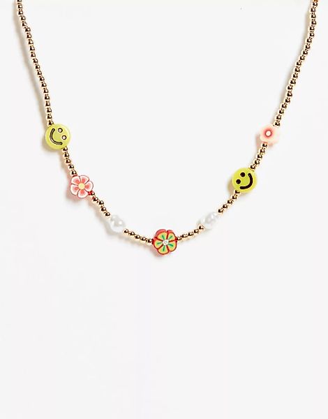 ASOS DESIGN – Goldfarbene Halskette mit Blüten- und Smiley-Details günstig online kaufen