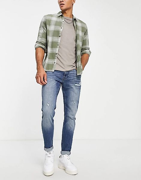 Hollister – Superskinny-Jeans in mittlerer Waschung im geschlitzten Used-Lo günstig online kaufen