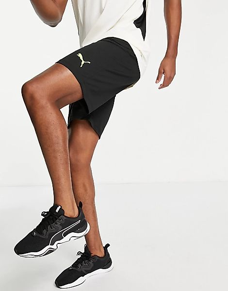 PUMA – Individual Rise – Shorts in Schwarz-Gelb günstig online kaufen
