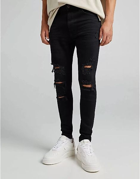 Bershka – Jeans in Schwarz mit superengem Schnitt, Rissen und ausgefranstem günstig online kaufen