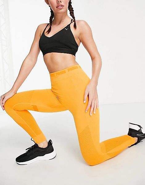 Puma – Training Evoknit – Nahtlose Leggings in Orange-Gelb günstig online kaufen