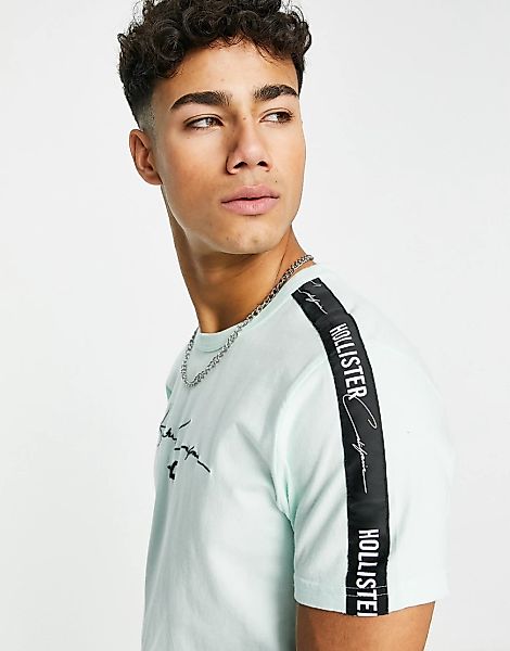 Hollister – T-Shirt in Minzgrün mit Schriftzug vorne und farblich abgestimm günstig online kaufen