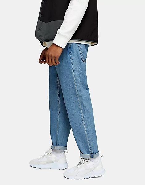 Topman – Locker geschnittene Jeans in mittlerer Waschung-Blau günstig online kaufen