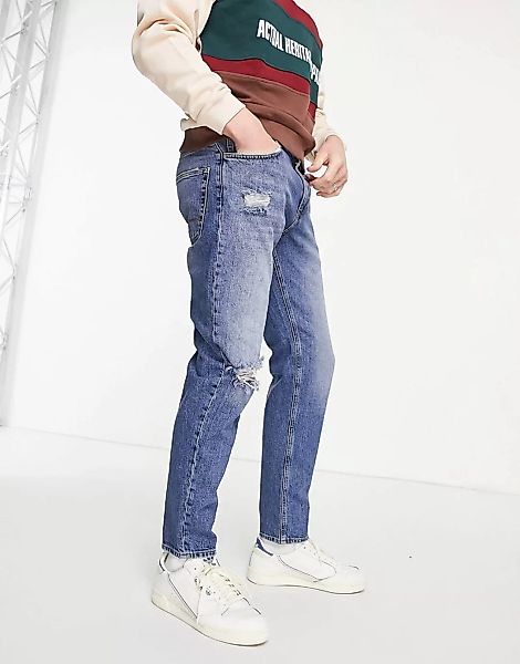 ASOS DESIGN – Schmal zulaufende Jeans in mittlerer Vintage-Waschung mit Ris günstig online kaufen
