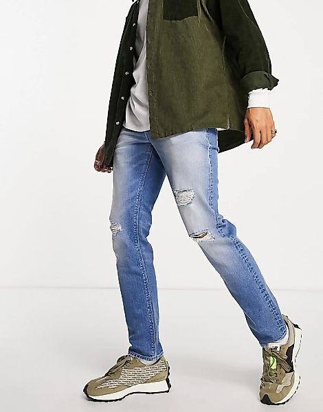 ASOS DESIGN – Schmale Stretch-Jeans mit Rissen in verwaschenem Mittelblau günstig online kaufen