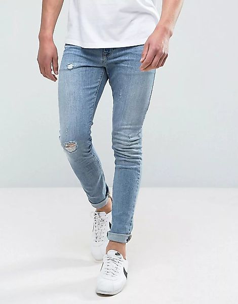 ASOS DESIGN – Superenge Skinny-Jeans in verwaschenem Mittelblau mit Abnutzu günstig online kaufen