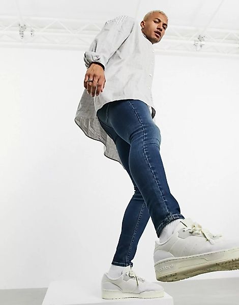 ASOS DESIGN – Spray-on-Jeans aus Powerstretch in verwaschenem Dunkelblau günstig online kaufen