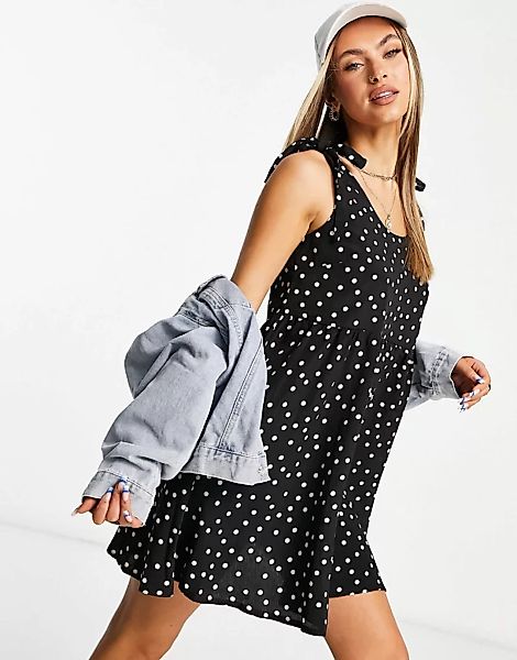 In The Style – Gepunktetes Trapez-Kleid in Schwarz mit gebundenen Schulterp günstig online kaufen